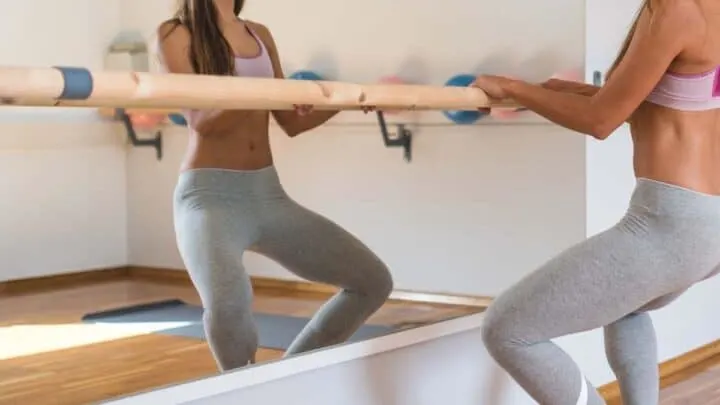 woman stretching at bar