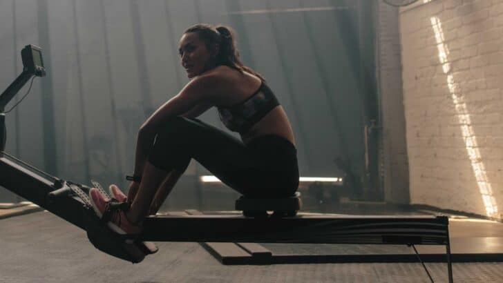 smiling fit woman on rowing machine