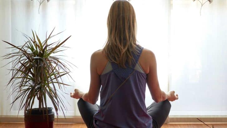 back of woman meditating