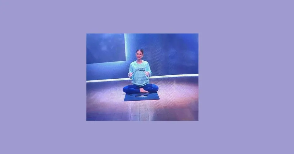 Peloton Instructor Anna Greenberg seated in yoga pose