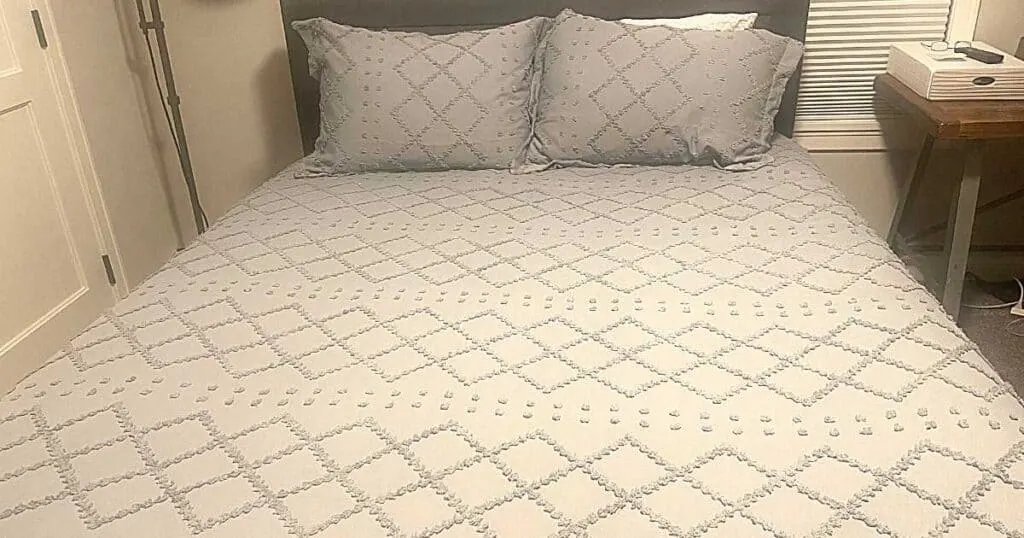 gray bedding on a bed