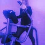 purple lighting woman on elliptical machine