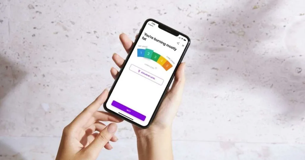 hand holding phone with lumen app burning fat