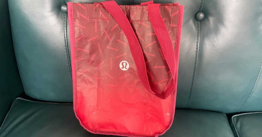 small lululemon red bag on teal sofa