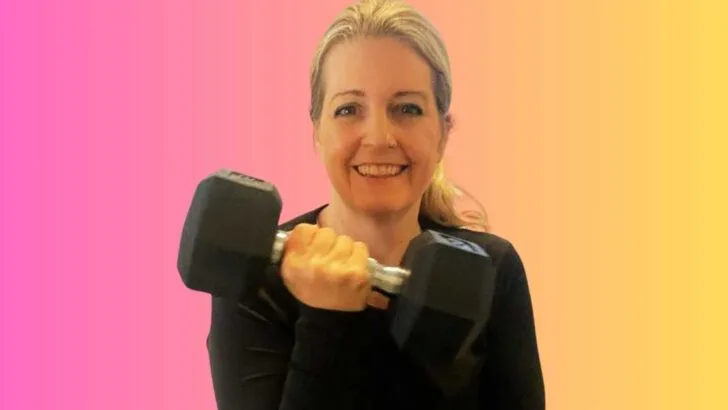 pink and orange background michelle platt lifting heavy dumbbell