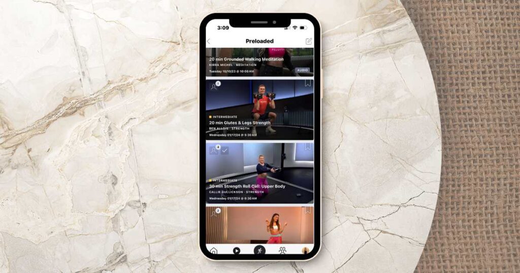 preloaded peloton classes on iphone sitting on a marble table