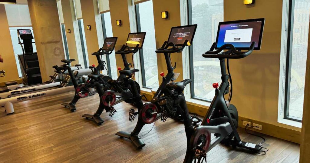 four peloton bikes in a row facing window in proper hotel in austin texas fitness center