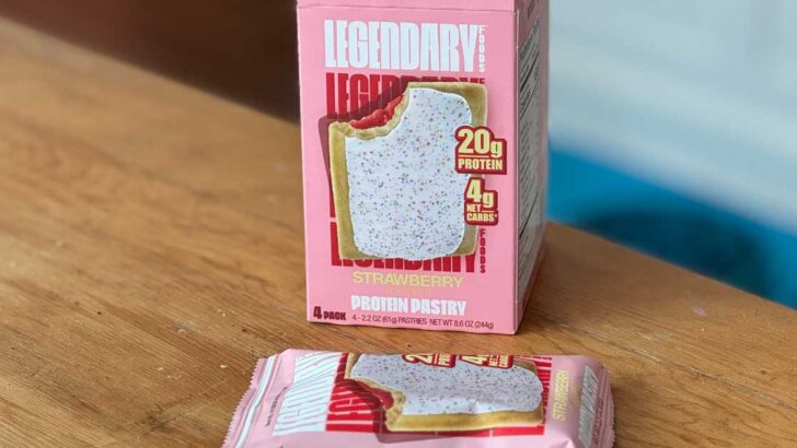 Legendary Protein Pastry box sitting on wooden table next to package.