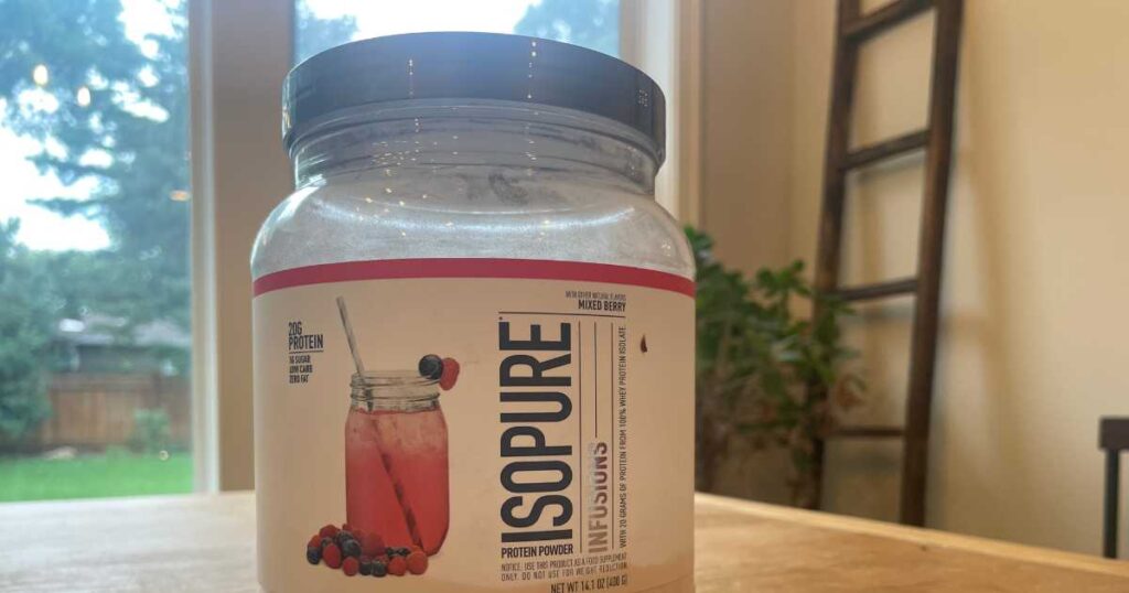Isopure Protein Powder infusions on brown wooden table.