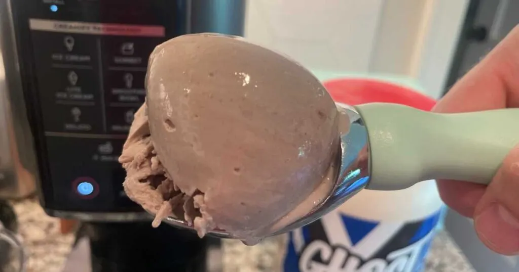 Light green ice cream scooper with a scoop of Ninja protein oreo ice cream.
